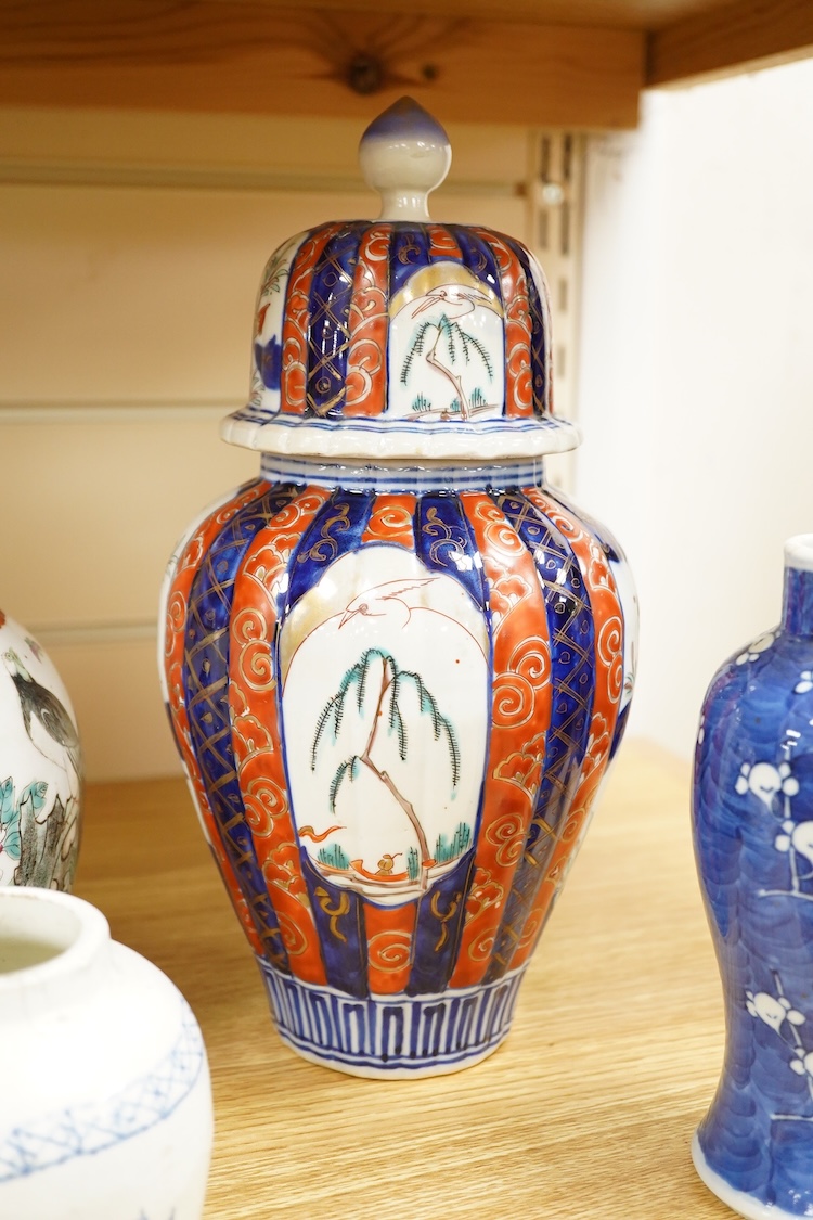 An Imari vase and cover-28cm high, a Chinese jar and prunus vase and a small blue and white jar.